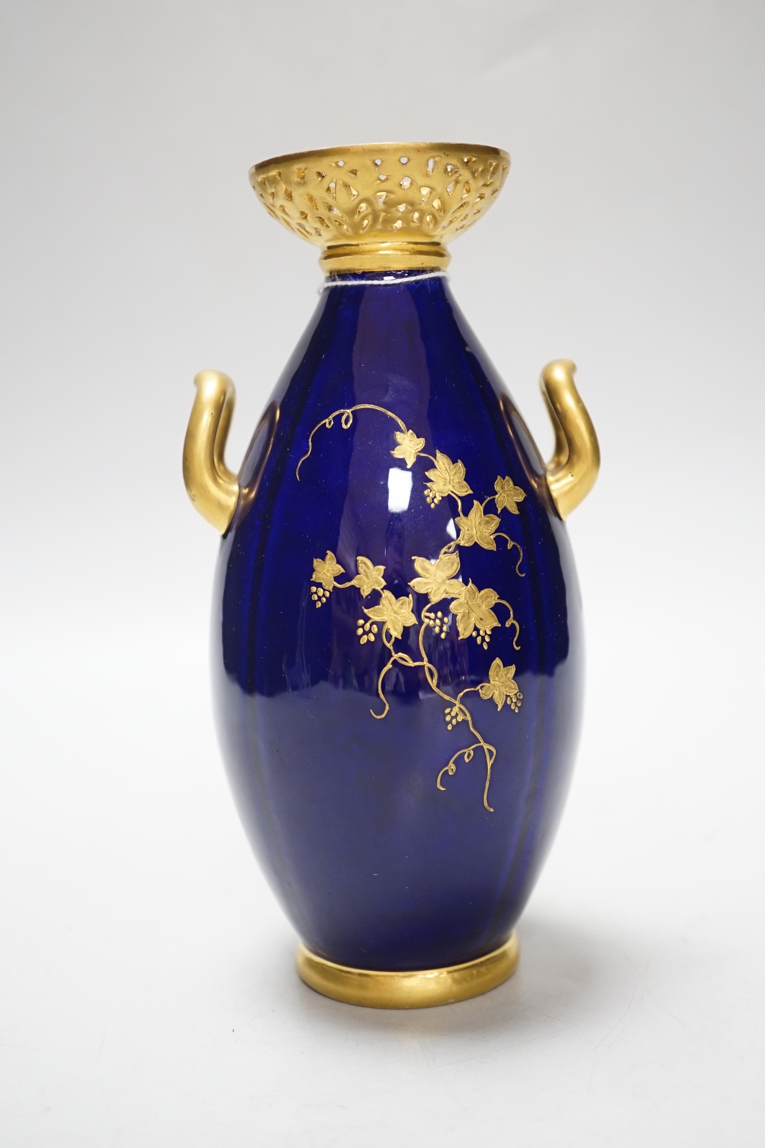 A Grainger & Co. Worcester two handled vase painted with a fox hunting scene in a raised gilt panel on a cobalt blue ground, having a reticulated gilt neck, date mark 1898, 19cm high